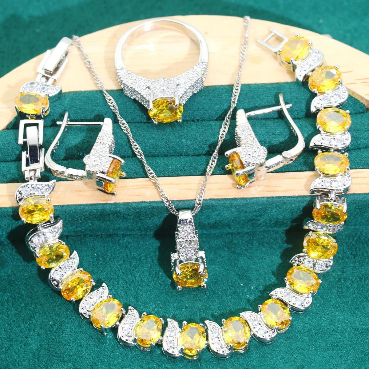 Four-piece bridal zircon jewellery set showing necklace, bracelet, earrings, and ring in a choice of colours.