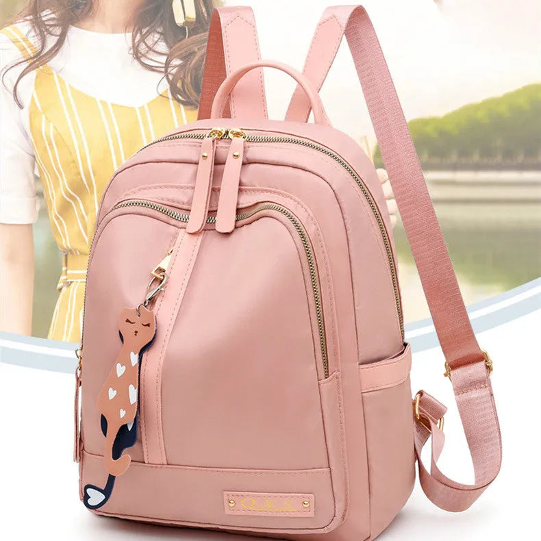 Black nylon women's casual backpack with internal pockets and double shoulder straps.