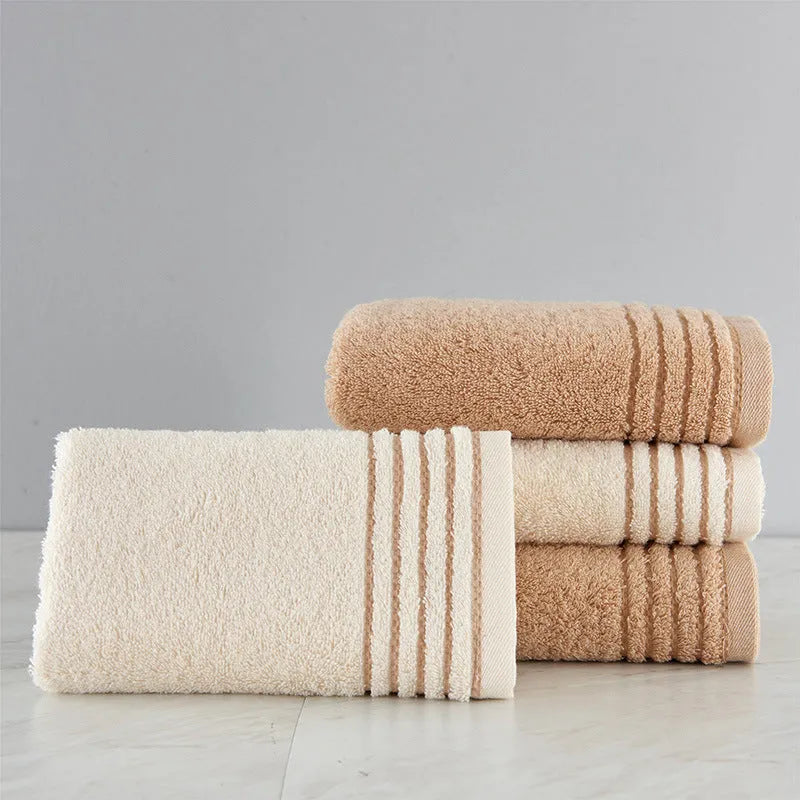 Cotton towel set in beige and brown showing three different sizes including large bath towel