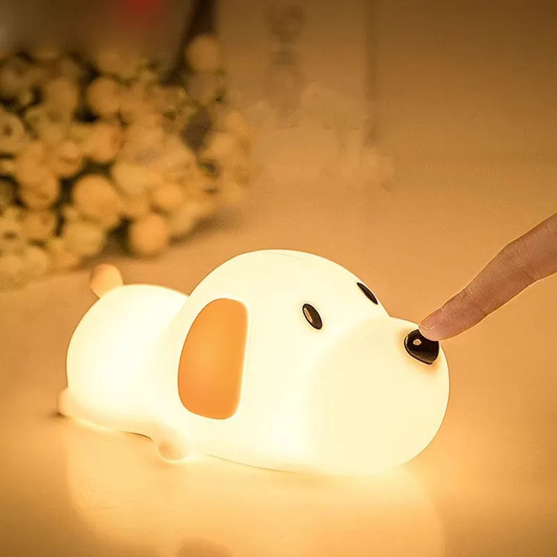 Small two-tone cartoon dog shaped silicone night lamp with USB charging port.