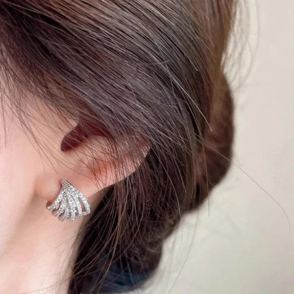 A pair of platinum-coloured geometric line design zircon earrings.