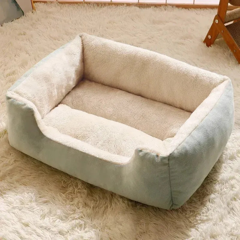 Soft short plush cat bed in grey, shown in a medium size for scale with a cat.