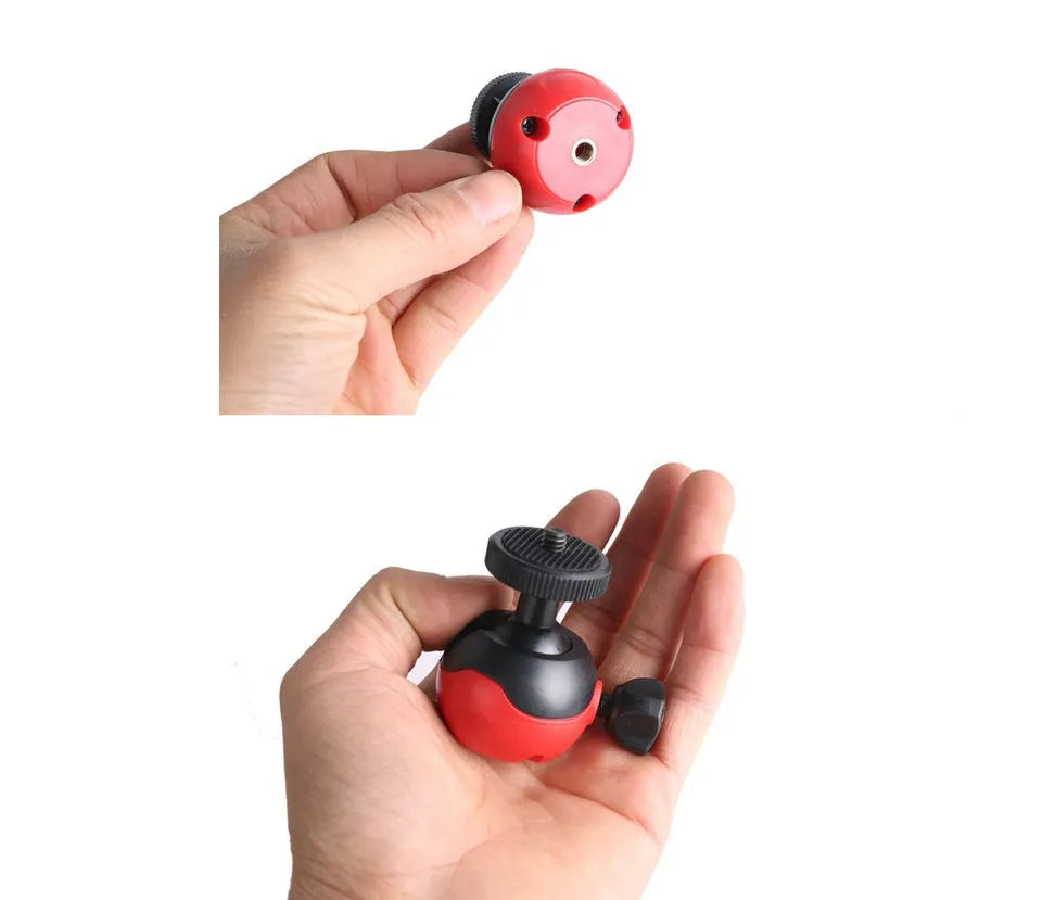 Black octopus tripod with spherical gimbal head wrapped around pole supporting mobile phone