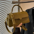 Beige women's square messenger bag with a top handle and shoulder strap, showing an outer pocket.