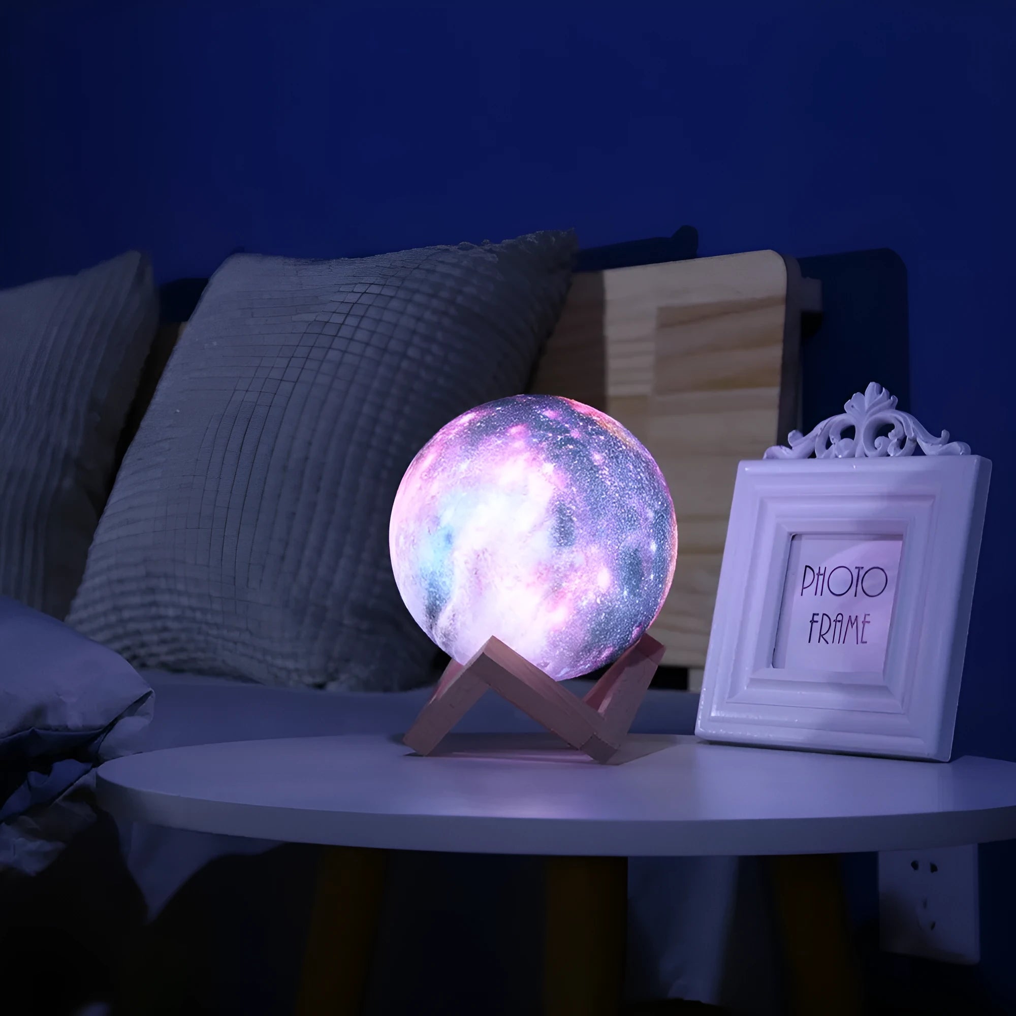 3D printed spherical lunar lamp with colour changing LED light on a surface.