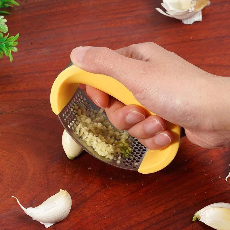 Stainless steel garlic press with non-slip handle in available colours crushing garlic
