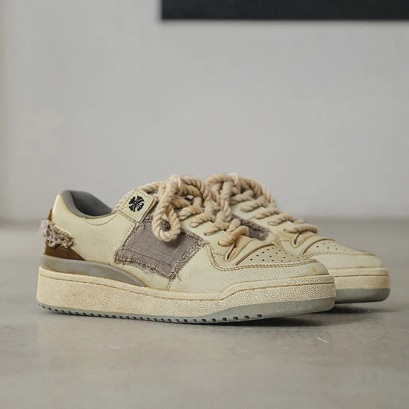 Beige low-top vintage skateboard shoes with round toe and rubber sole on a white background