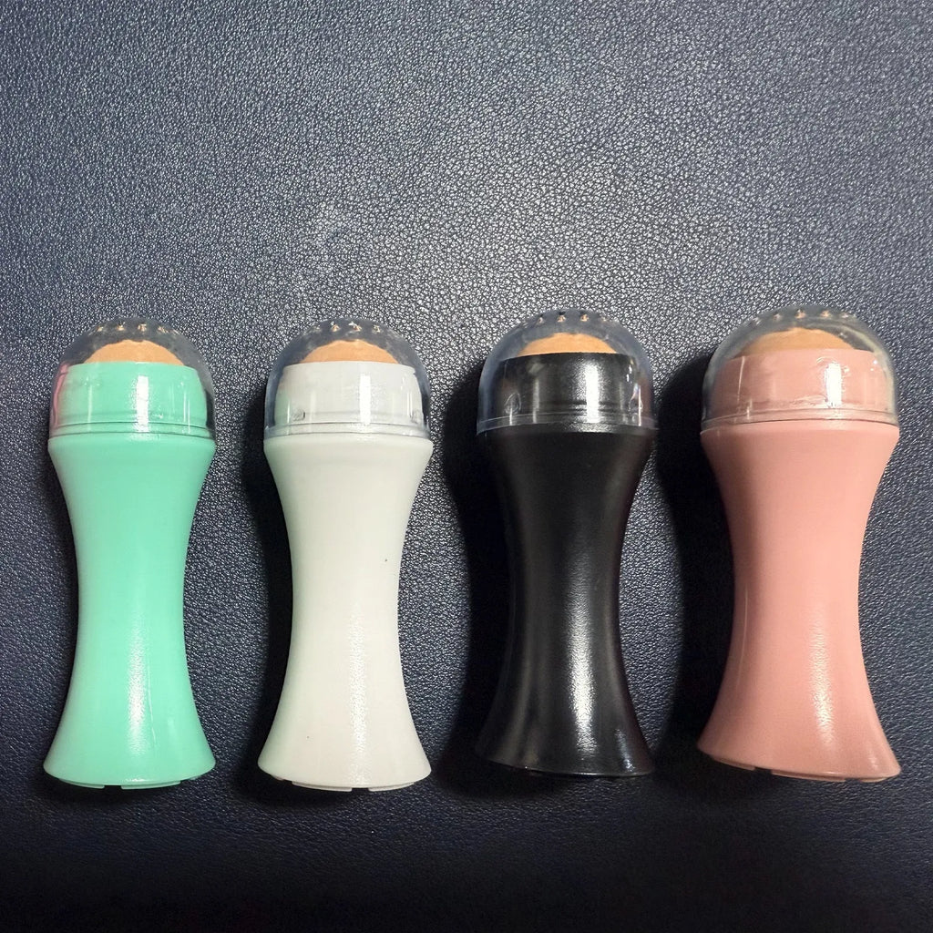 Portable volcanic stone facial roller for oil control, shown in choice of black, green, pink, or white.