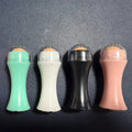 Portable volcanic stone facial roller for oil control, shown in choice of black, green, pink, or white.