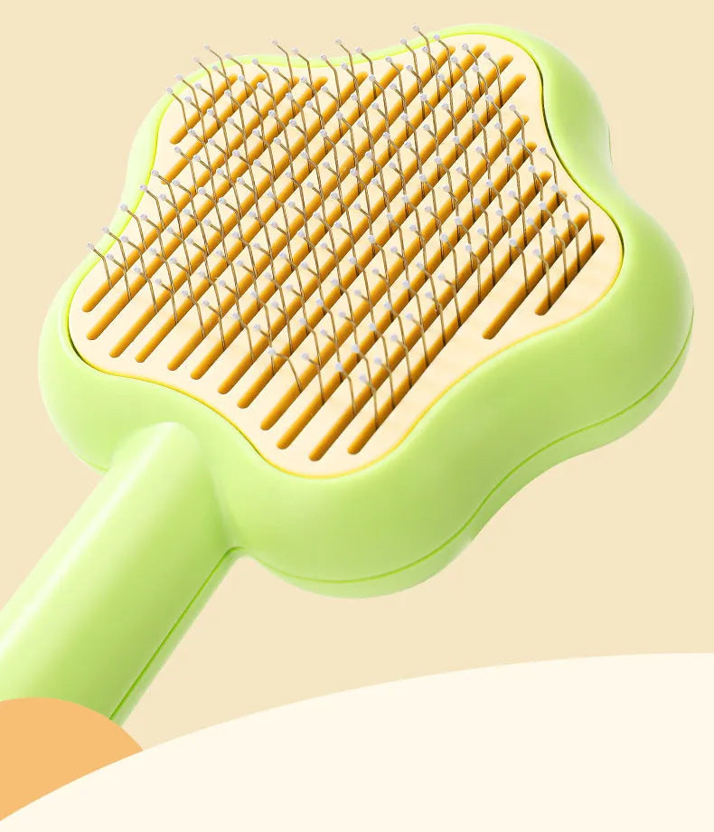 Green or yellow handheld self-cleaning magic wand pet comb with stainless steel needles.