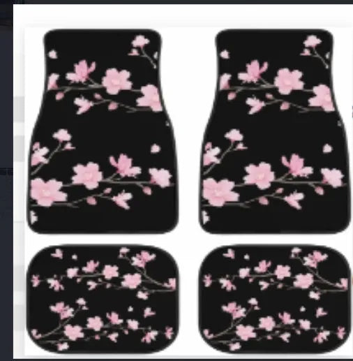 Set of four black printed rubber car floor mats with textured surface, showing thickness.