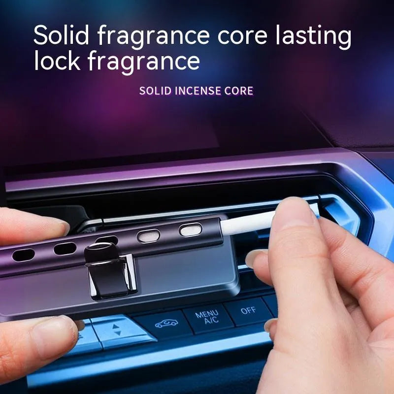 Black car air vent perfume diffuser with LED light attached to dashboard vent