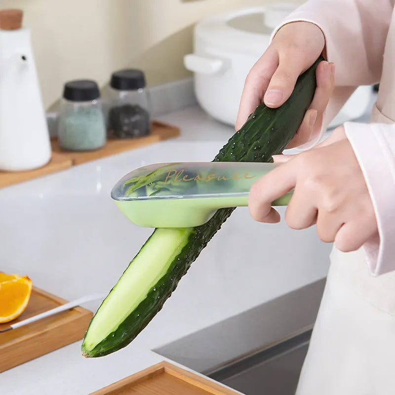 Dark green kitchen peeler with storage tube and stainless steel blade for vegetables