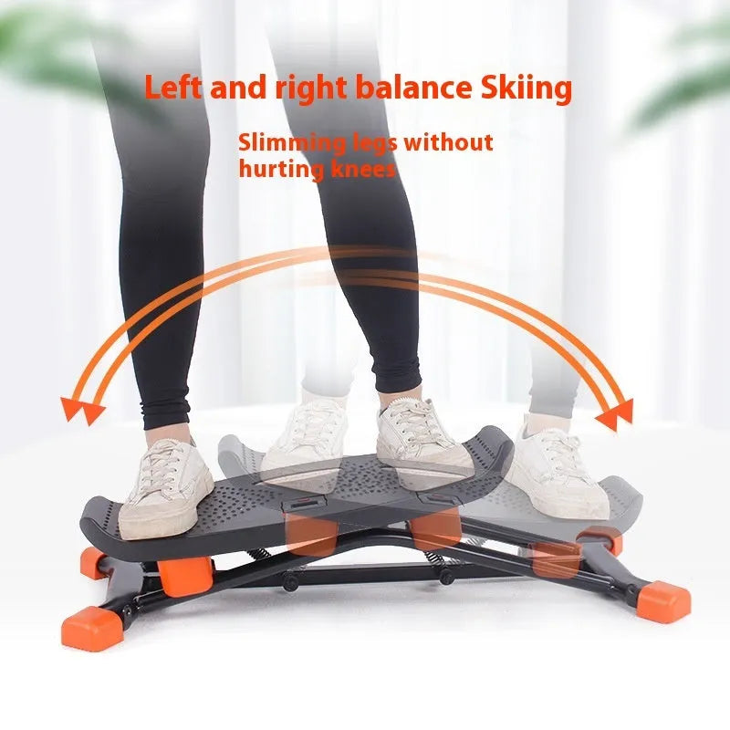 Black JS101A mini indoor fitness skiing machine with elastic hand straps on a flat surface.