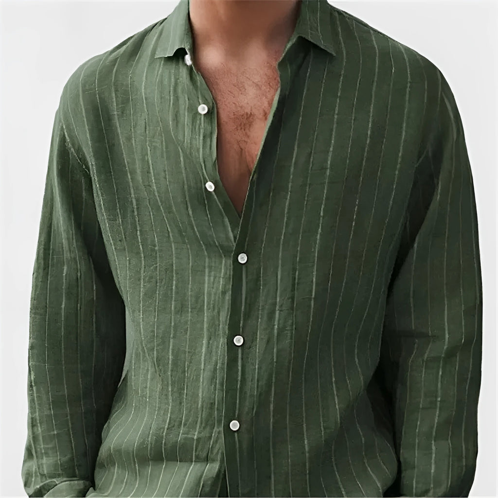 Man wearing a loose fit, short sleeve, striped cardigan shirt in a casual setting.