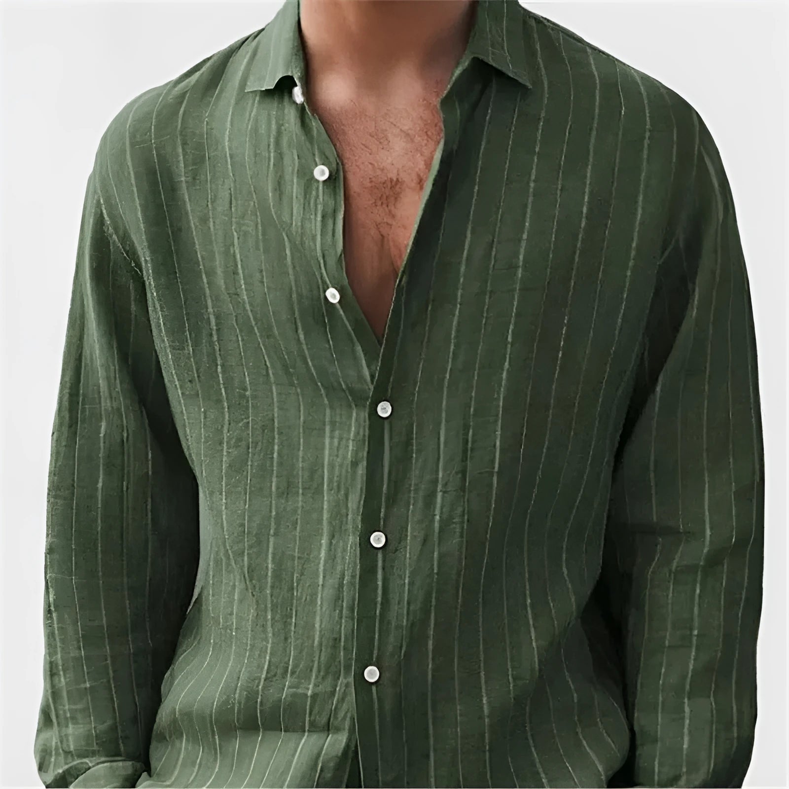 Man wearing a loose fit, short sleeve, striped cardigan shirt in a casual setting.