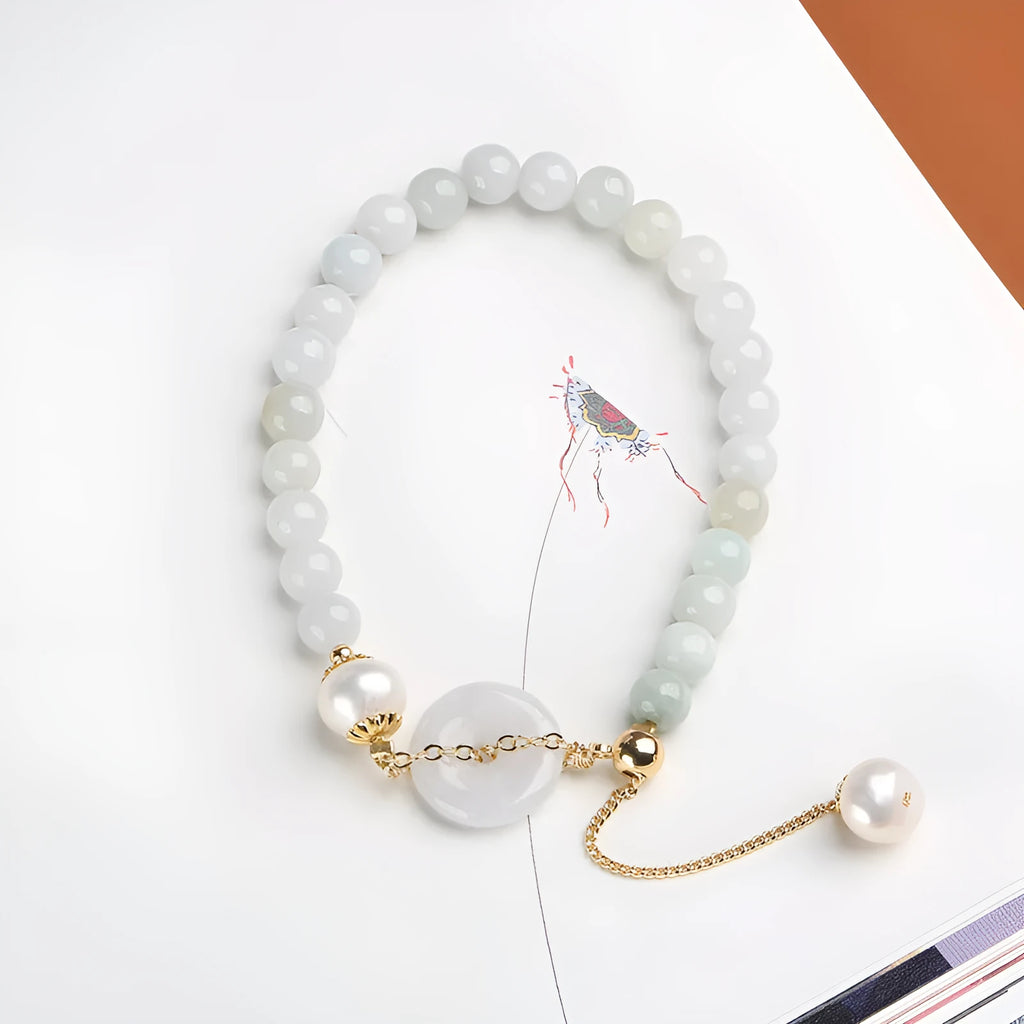 Natural jade bracelet with geometric shape, round pendant, and peace buckle closure on a wrist.
