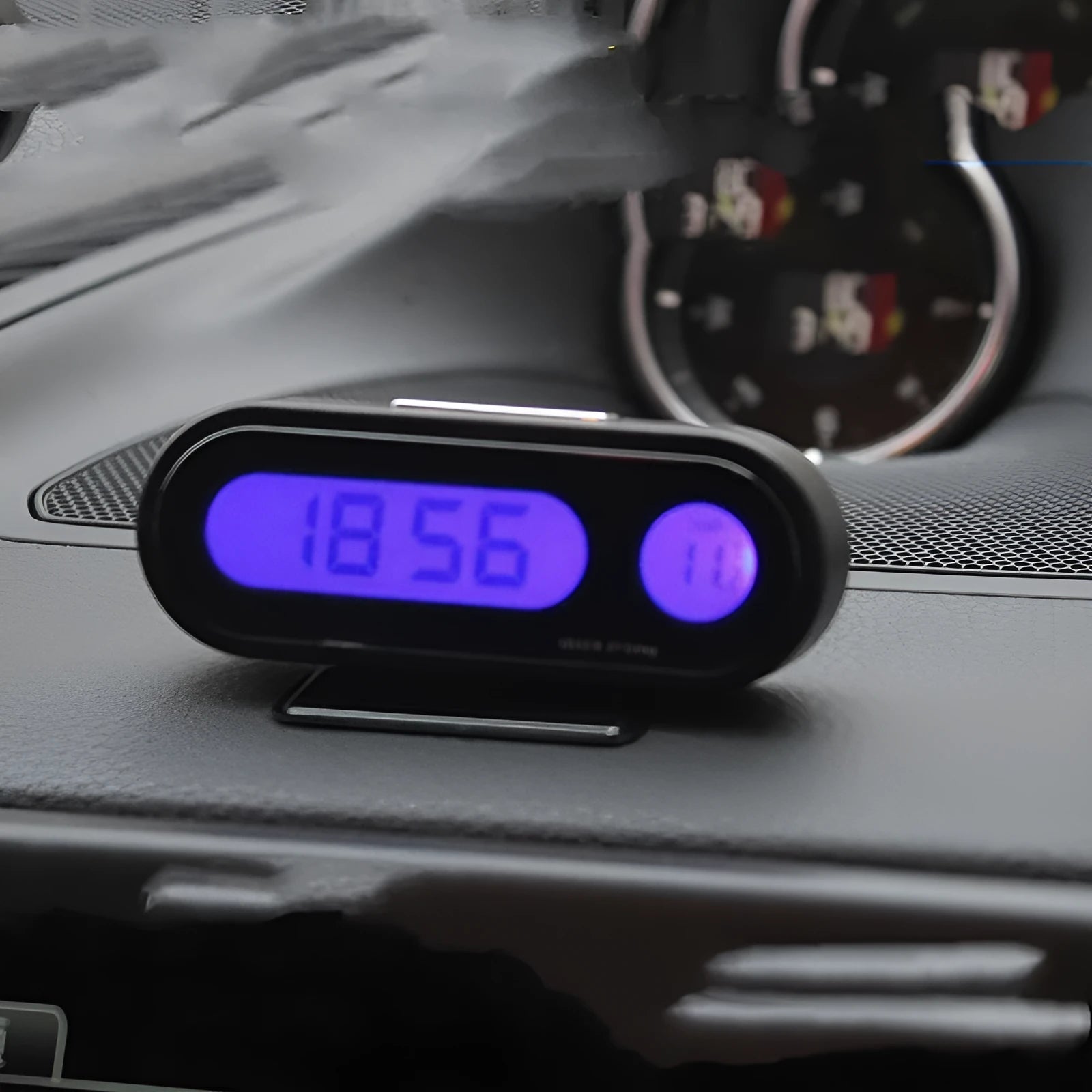 Black digital car dashboard clock and thermometer with LED display on an adjustable mounting bracket.