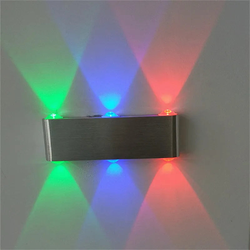 Silver aluminium rectangular LED wall lamp mounted on a wall displaying multiple colour options