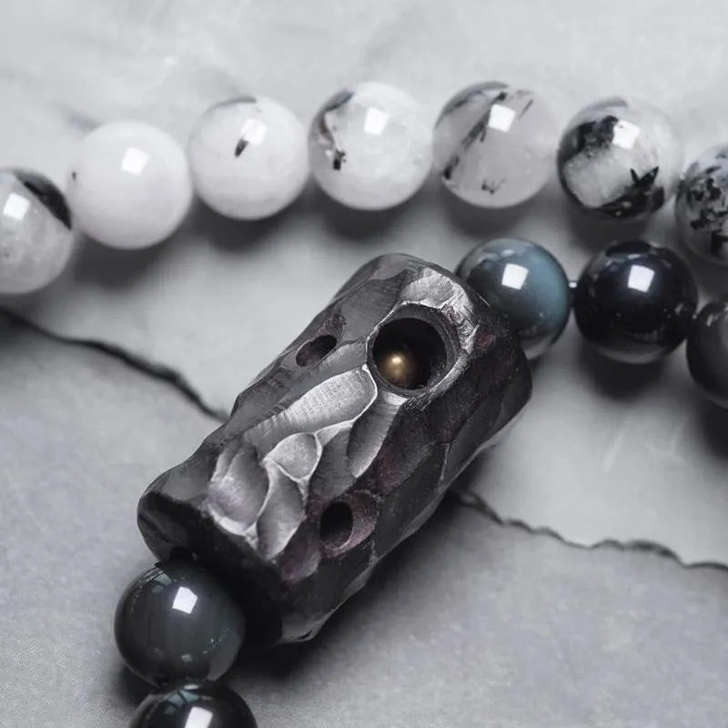 Men's black hair bracelet with white crystal tassel showing ethnic design and adjustable sizing