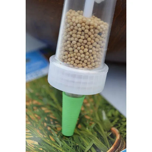 Compact 12 cm long plastic mini planter tool for sowing seeds in pots and trays.