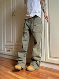 Green cotton workwear pants with double zipper and pockets on mannequin