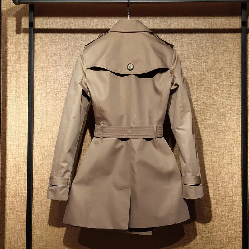 Women's khaki trench coat with double-breasted front and flight sleeves on hanger