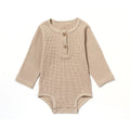 Long sleeve waffle cotton baby romper in neutral colour on hanger