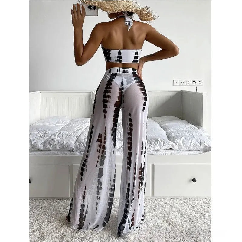 Women's black and blue printed three-piece swimsuit set with mesh trousers.