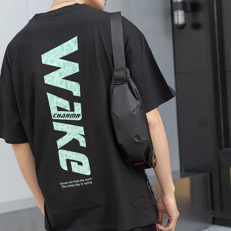 Black Oxford cloth men's crossbody waist pack showing front zipper and interior organisation pockets.