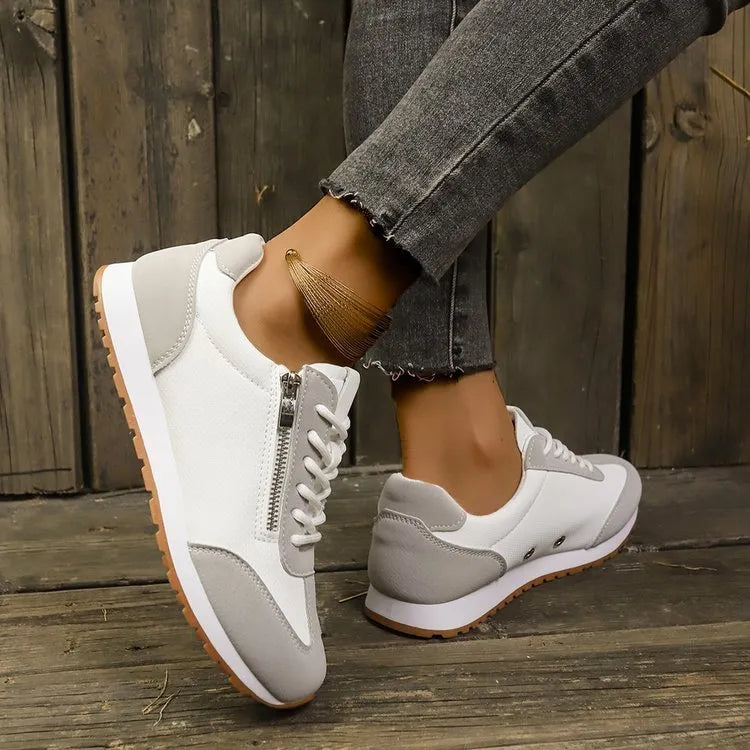 Women's flat-heeled shoe in artificial PU, available in grey, white, and champagne, with a rubber sole