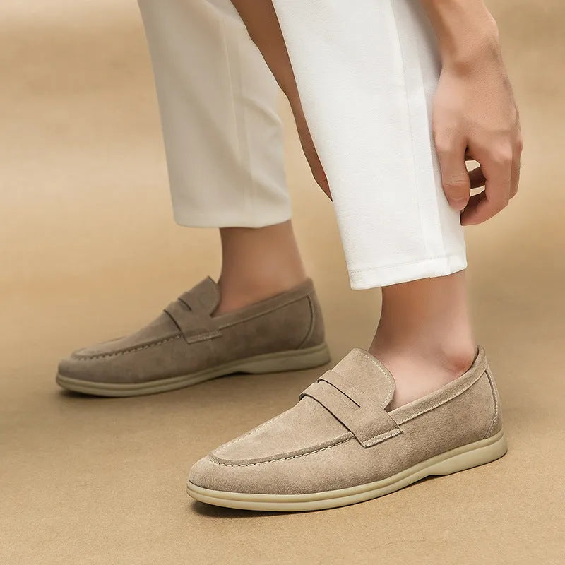 Men's beige leather slip-on casual shoes with round toe and rubber sole on a white background.