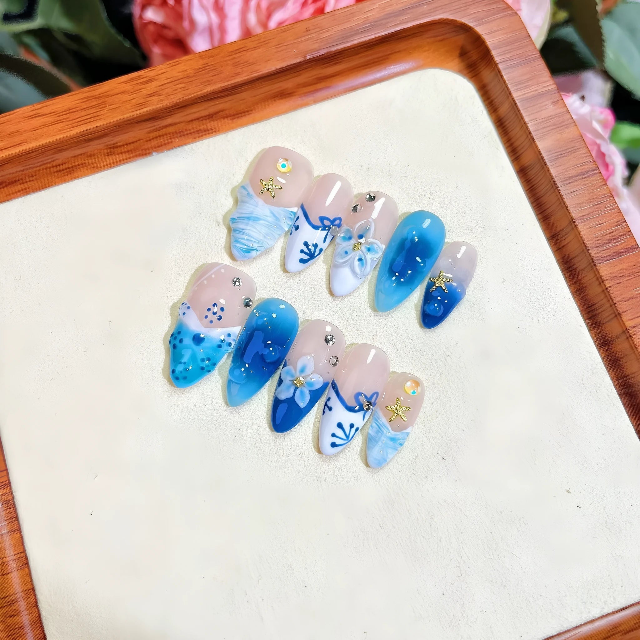 Blue hand-painted carved summer ice transparent plastic fake nails set showing carved detailing and four size options