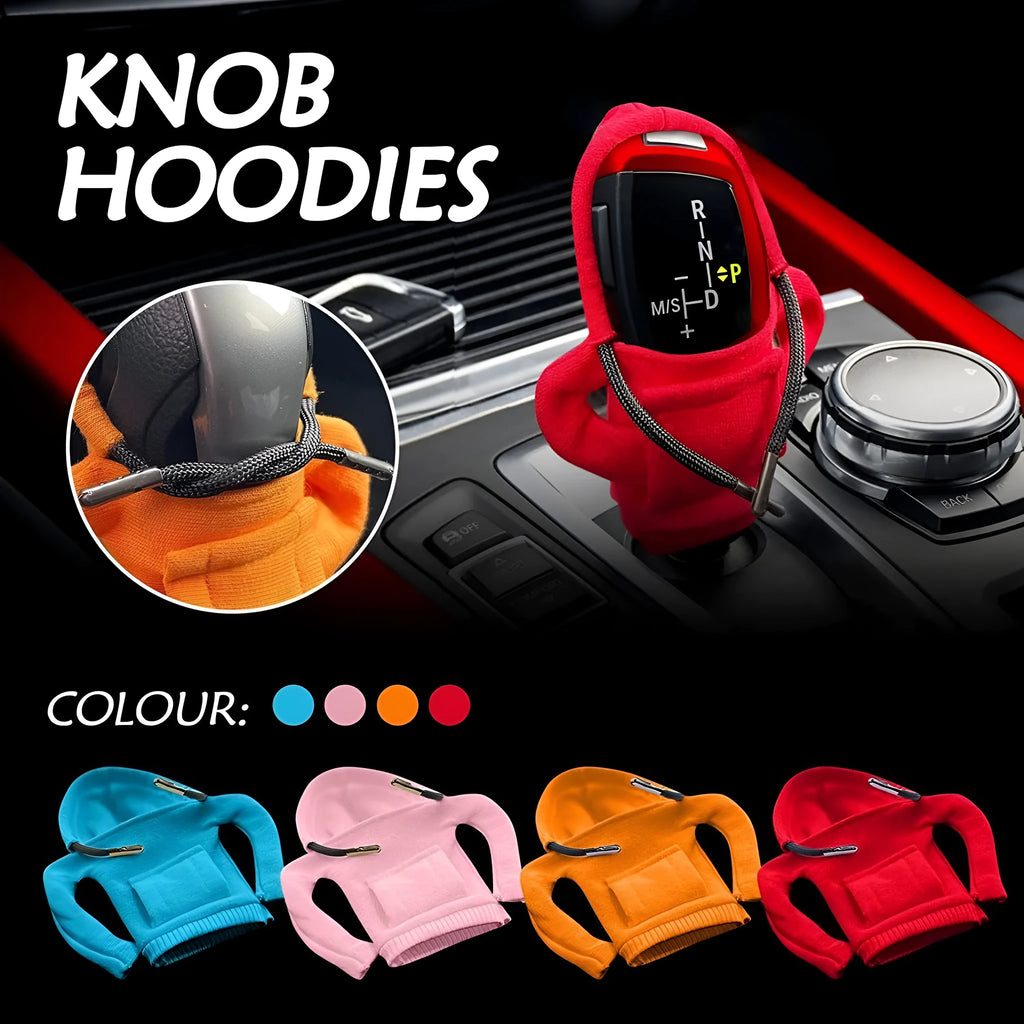 Blue cloth cover fitted over a car gear shift knob showing sewing detail