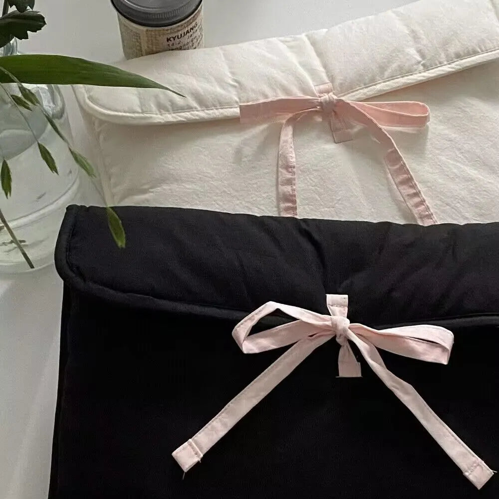 Women's quilted laptop bag with bow detail in nylon, showing striped lining and size options