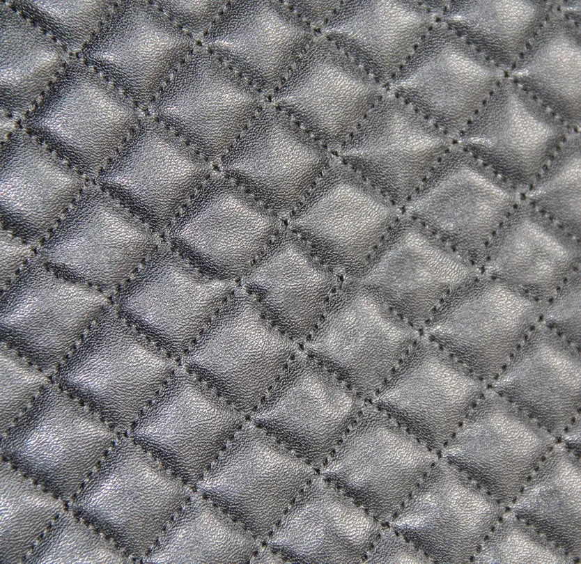 Black quilted automotive seat cover made of PU leather composite material with plastic hooks.