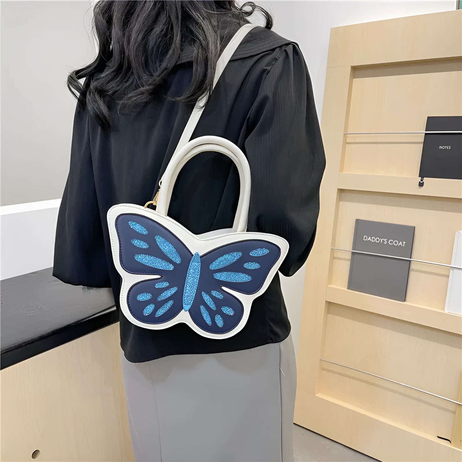 Square crossbody bag in PU material with contrast colour detailing showing white, pink, blue, and black colour options