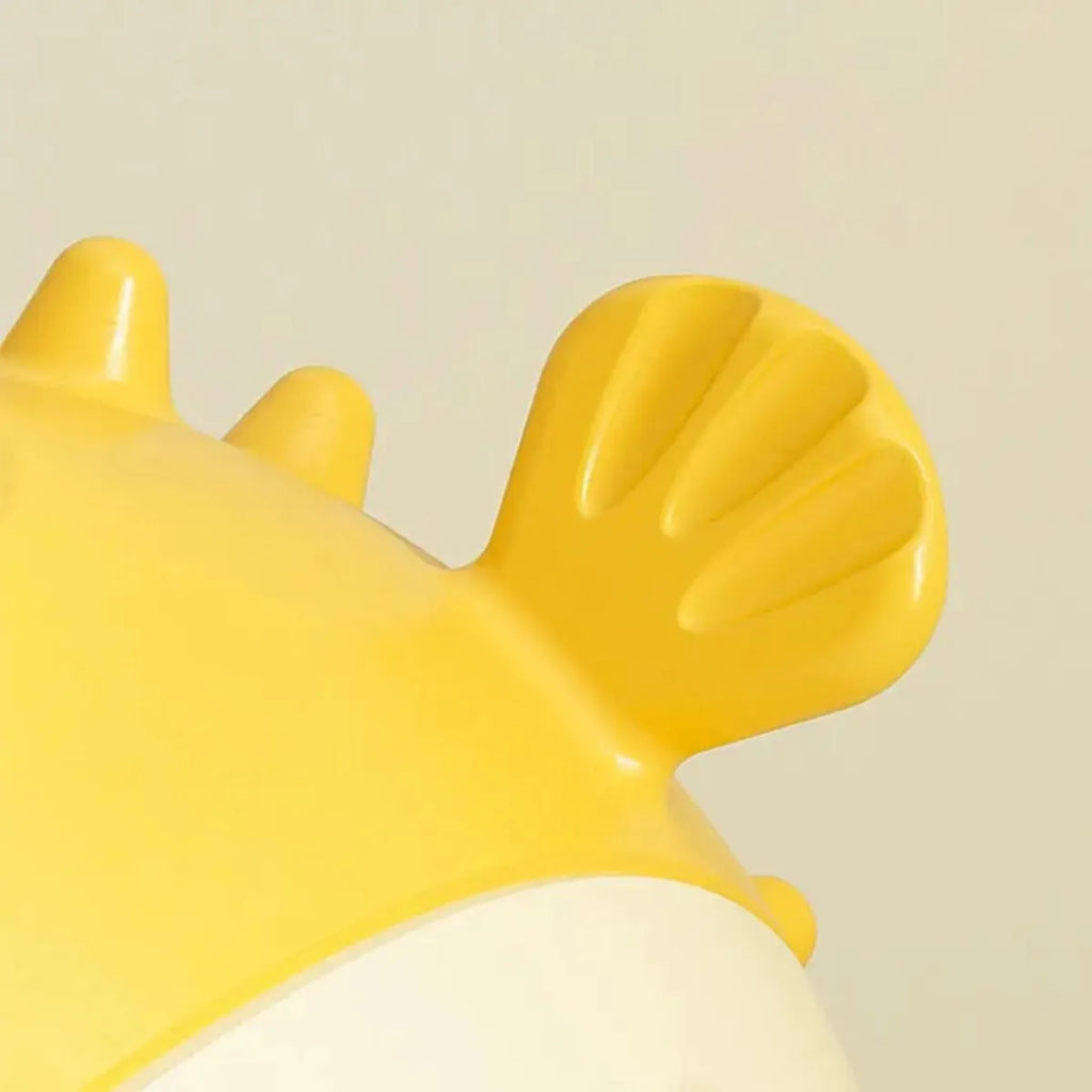 Yellow durable fish-shaped vinyl dog chew toy with textured surface and squeaker.