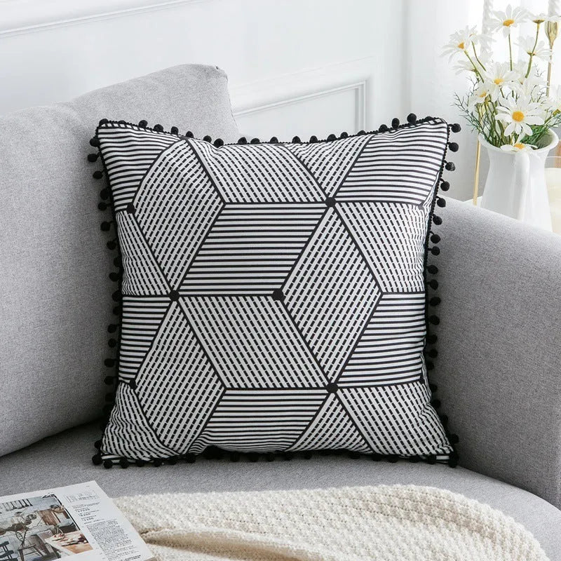 Bohemian national style throw pillow cushion cover in light grey on a sofa.