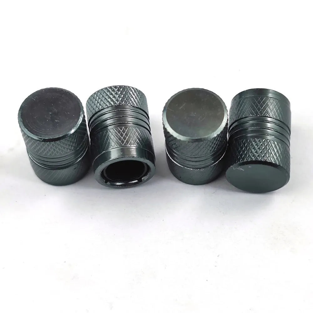 Aluminium car tyre valve dust cap in black, blue, grey, and red colours.
