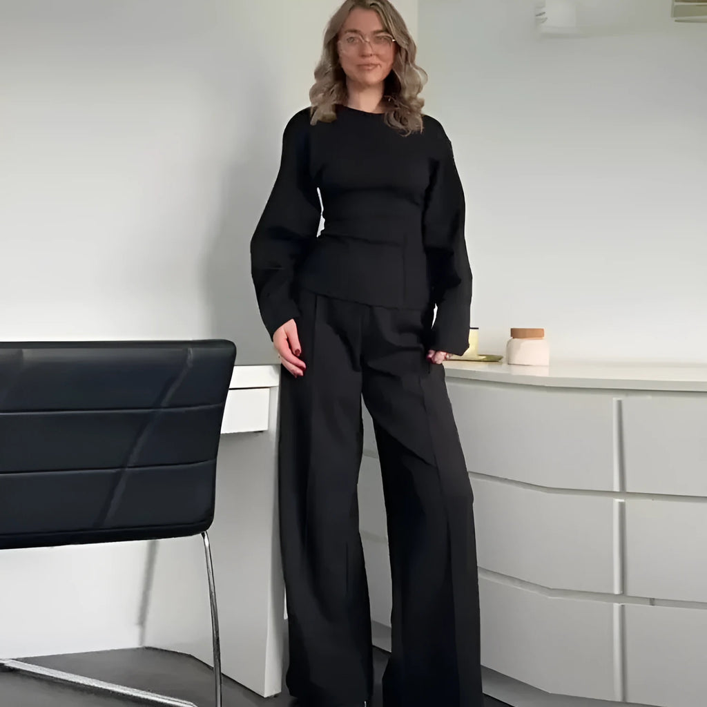 Women's black polar fleece suit set with long sleeve pleated top and wide leg trousers