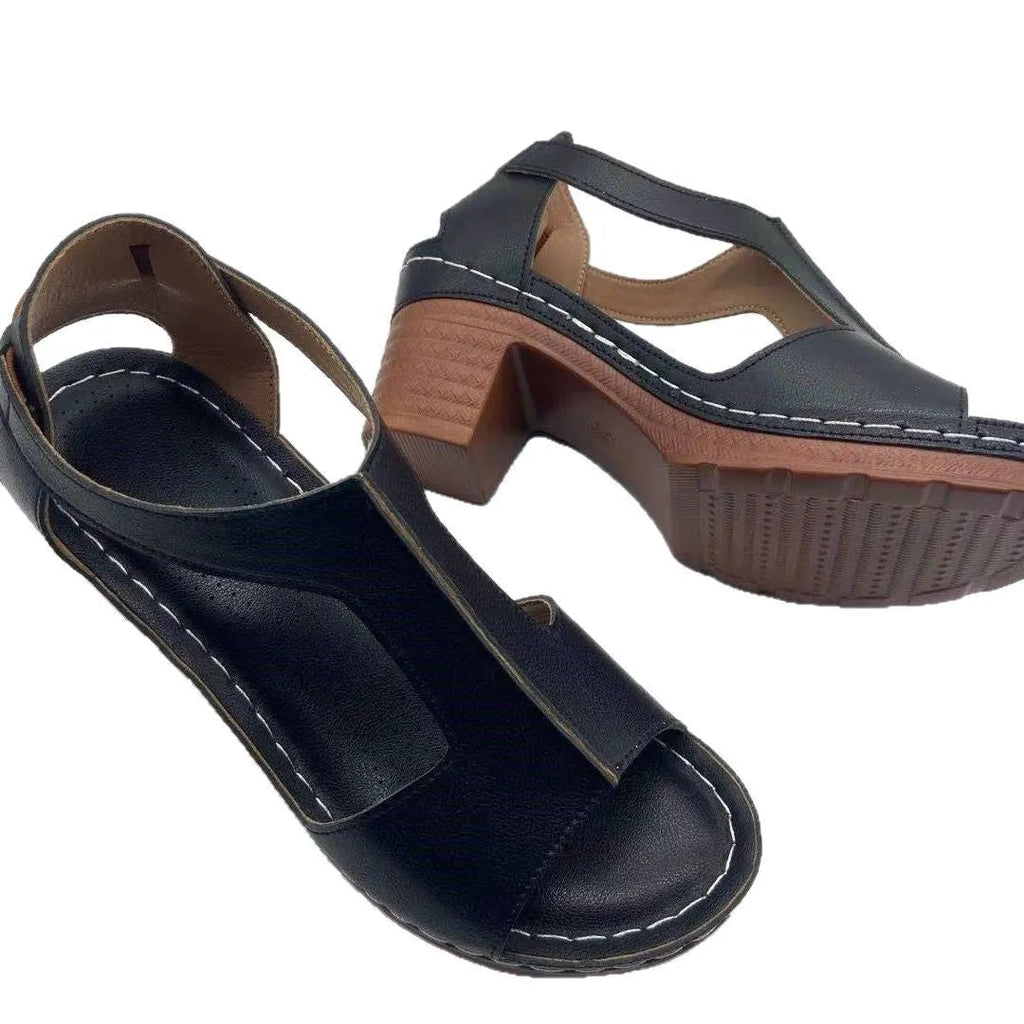 Womens beige Roman style wedge sandals with open peep toe and silver buckle strap on a low heel.