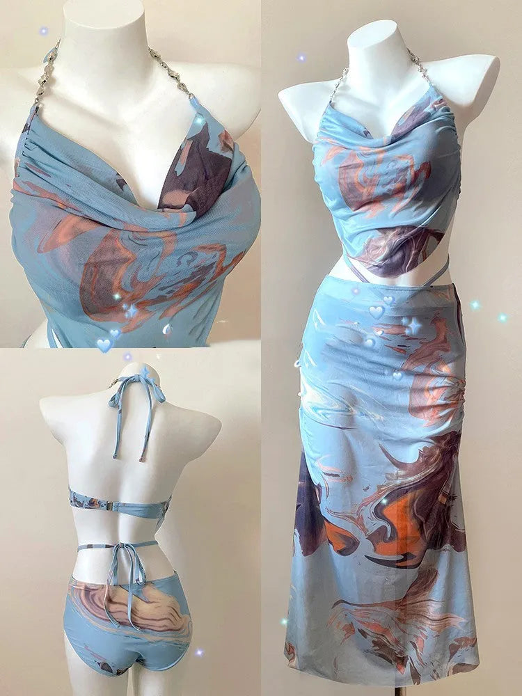 Blue printed women's three-piece bikini set with triangle top, bottoms, and skirt, showing steel support detail.