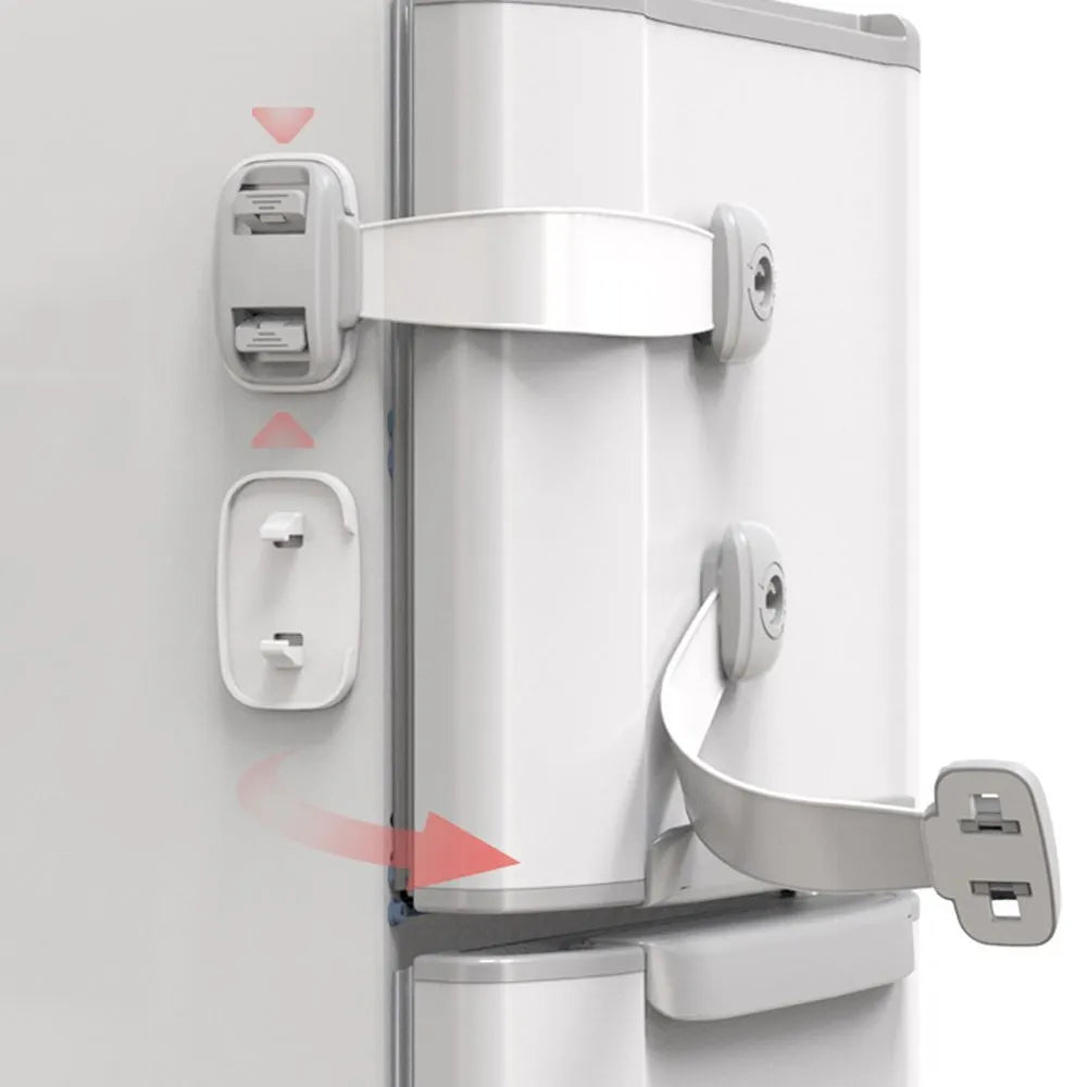 Grey and green adjustable child safety cabinet locks with adhesive backing on a kitchen drawer.