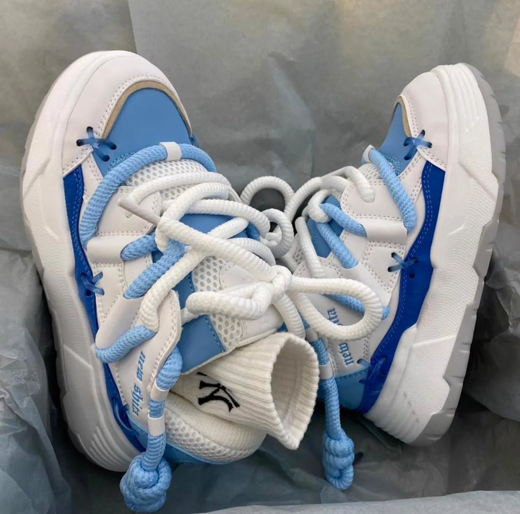 Women's thick sole grey retro sneakers with lace-up front and chunky rubber heel.