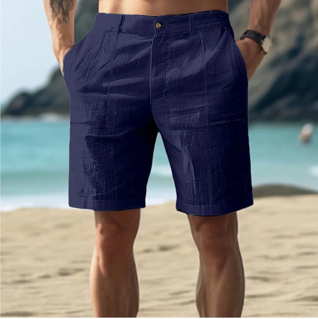 Men's solid colour cotton casual shorts with a mid waist and button fly, shown in dark blue.