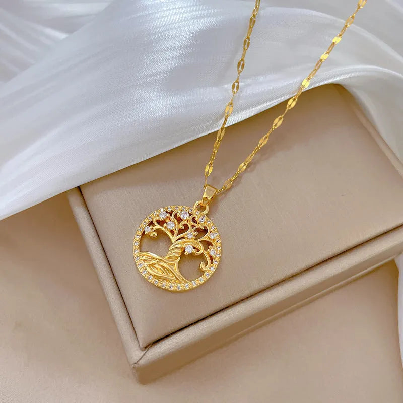Gold-plated adjustable necklace with a detailed rhinestone and mother-of-pearl lucky tree light pendant.