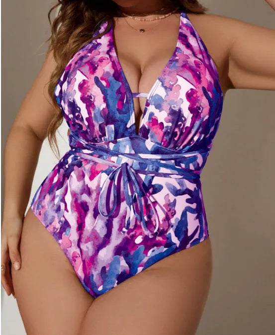 Purple or blue women's one-piece halter swimsuit on a hanger