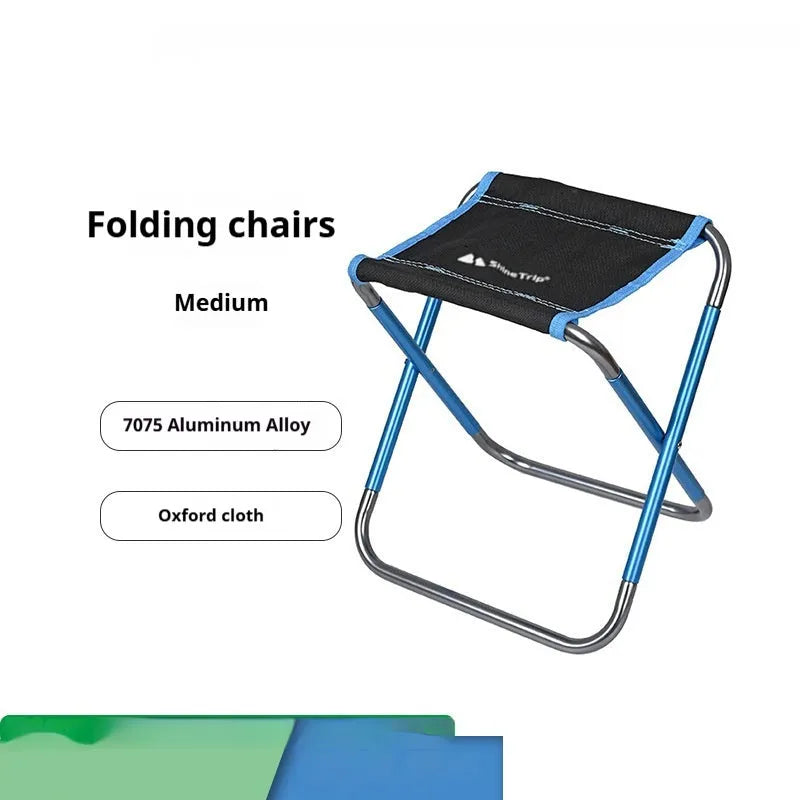 Black aluminium alloy folding camp stool in the open seating position.