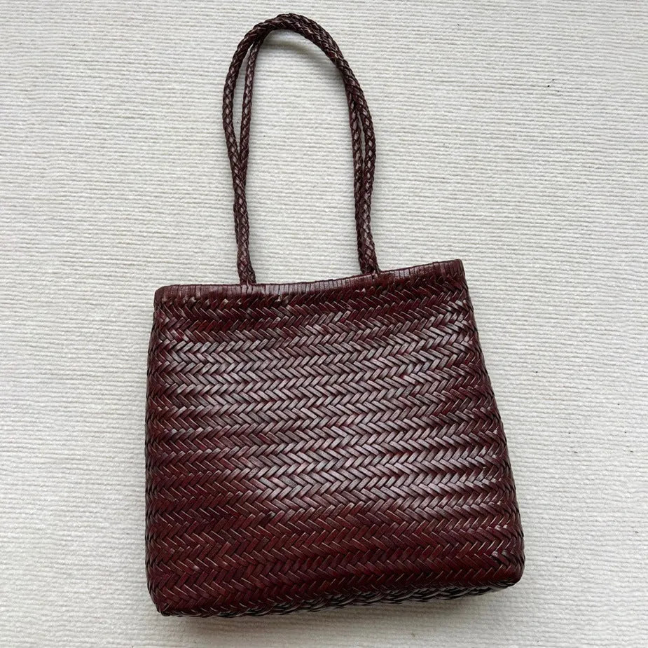 Brown handmade woven cowhide leather tote bag with a three-dimensional front pocket.